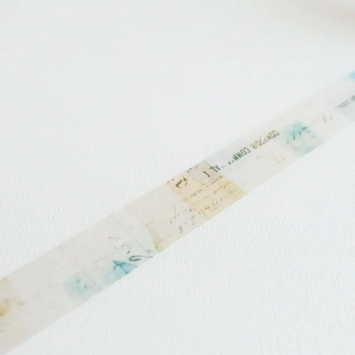 YOHAKU washi tape titled 'Secret Song' (Y-090), a collage design in muted blues, greens, and beige, featuring script and vintage-style typed letters, perfect for journals, crafts, and artistic layering.