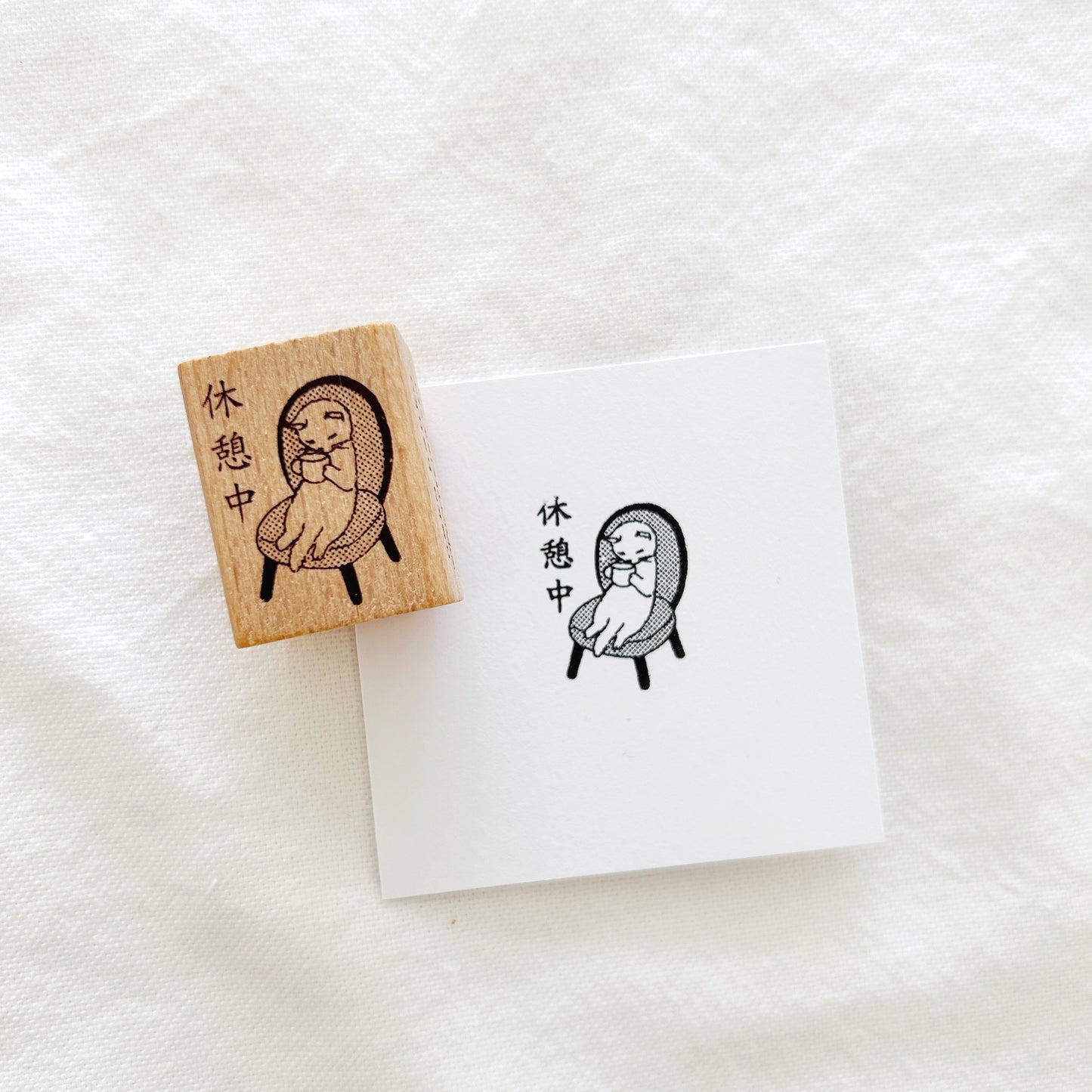 Wooden stamp of a cat having her afternoon tea