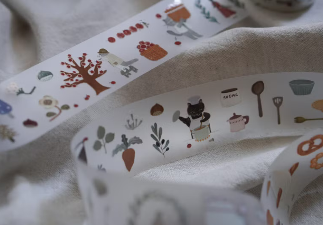 Ivy Snow matte PET tape titled 'The Forest Kitchen,' featuring charming illustrations of forest animals, fruits, and kitchen items, Japanese stationery ideal for adding a whimsical, nature-inspired touch to planners, journals, and crafts.