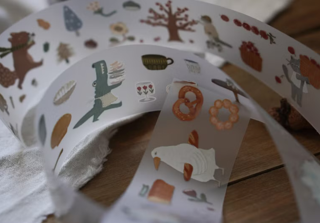 Ivy Snow matte PET tape titled 'The Forest Kitchen,' featuring charming illustrations of forest animals, fruits, and kitchen items, Japanese stationery ideal for adding a whimsical, nature-inspired touch to planners, journals, and crafts.