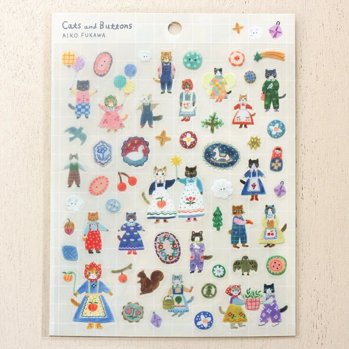 Aiko Fukawa clear sticker sheet titled 'Cats and Buttons,' featuring whimsical illustrations of playful cats and colorful buttons, Japanese stationery ideal for decorating planners, journals, and crafts.