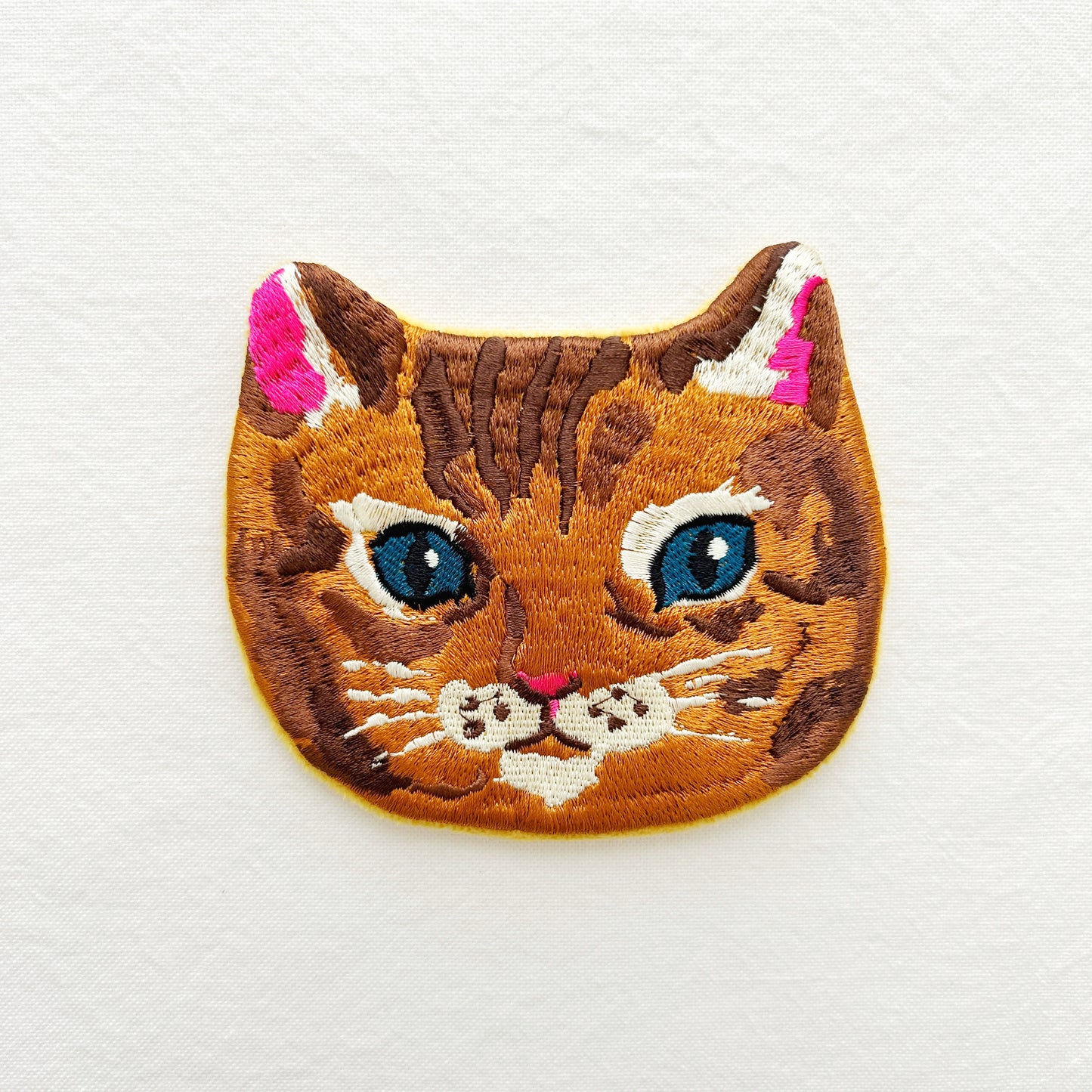 Embroidered pouch of a cat's face