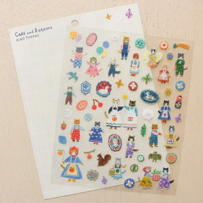 Aiko Fukawa clear sticker sheet titled 'Cats and Buttons,' featuring whimsical illustrations of playful cats and colorful buttons, Japanese stationery ideal for decorating planners, journals, and crafts.