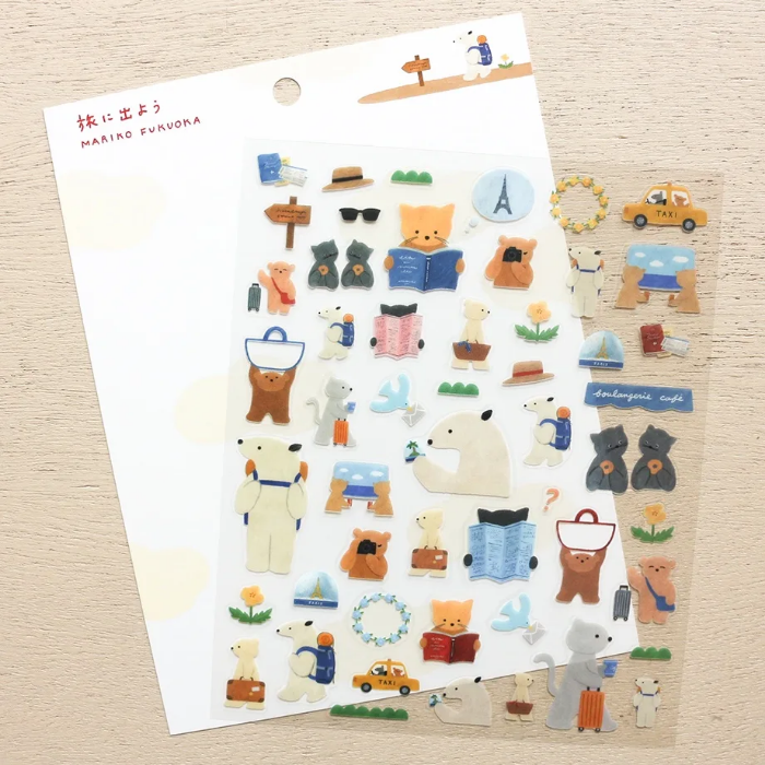 Mariko Fukuoka clear sticker sheet titled 'Let's Go On A Trip,' featuring playful travel-themed illustrations of luggage, maps, and cute characters, Japanese stationery perfect for decorating planners, journals, and scrapbooks.