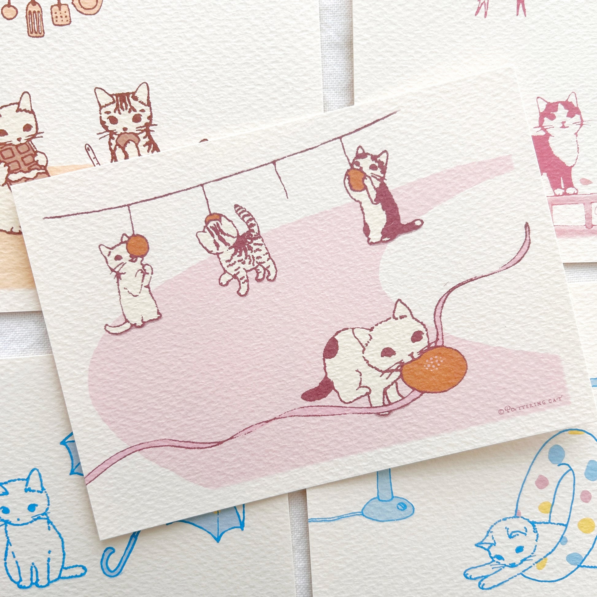 A collection of postcards with cute cat illustrations