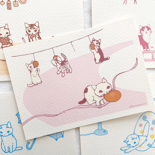A collection of postcards with cute cat illustrations