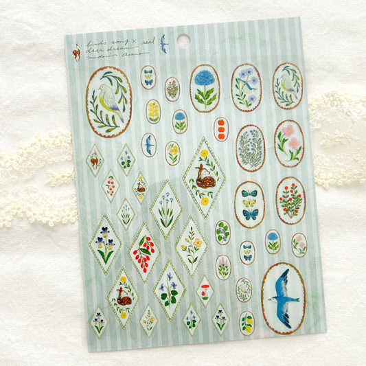 Sheet of decorative stickers with nature-themed designs of birds and flowers on a light blue background