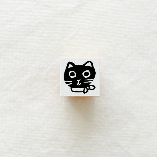 Small square wooden rubber stamp with a black cat.