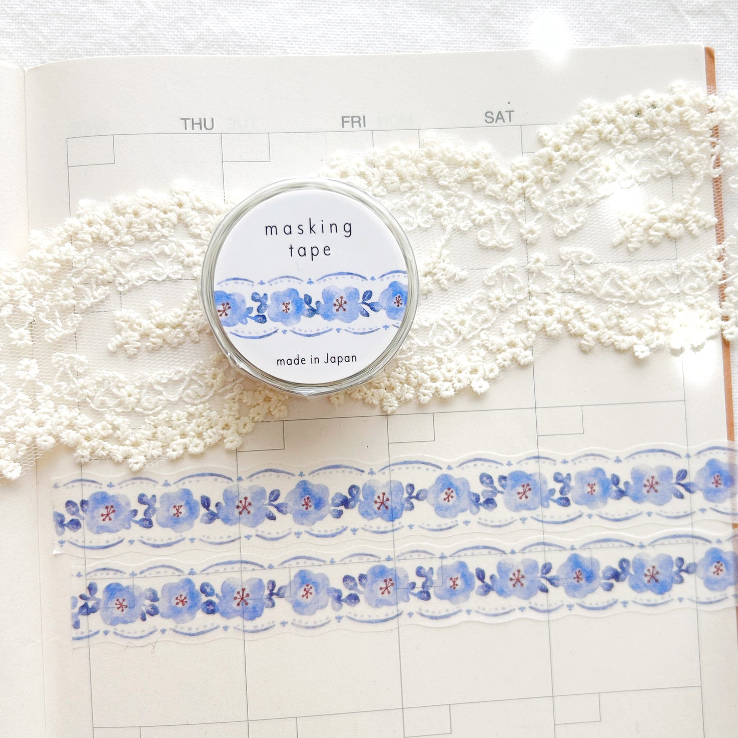 Washi tape with blue floral design on a planner