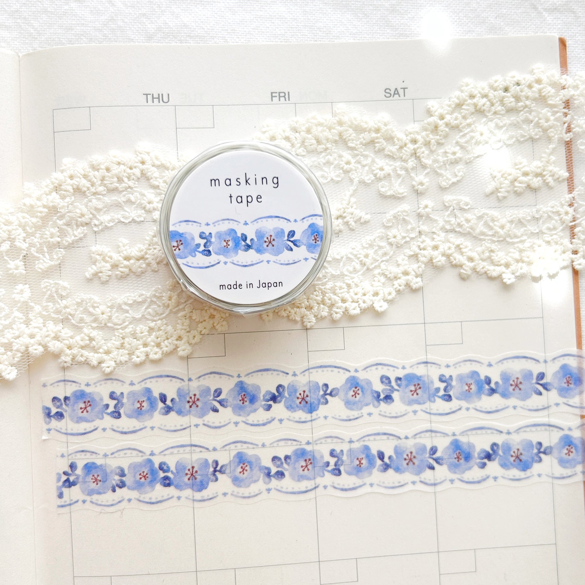 Washi tape with blue floral design on a planner