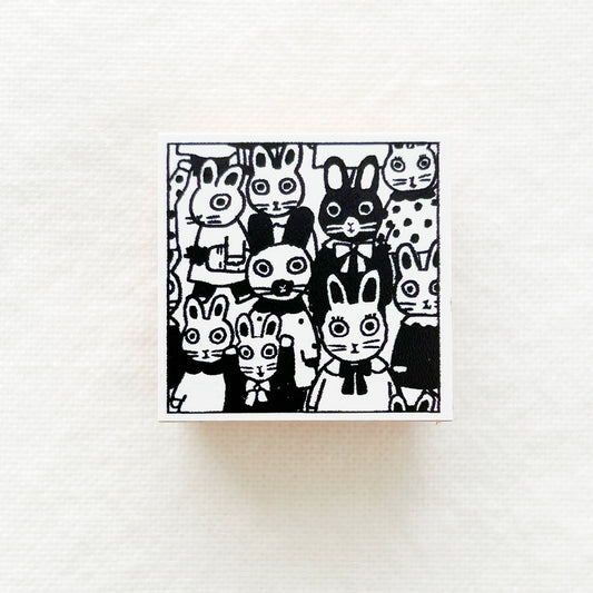 A square wooden rubber stamp of bunnies