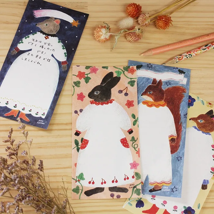 Aiko Fukawa memo pad titled 'Paper Dress,' featuring elegant illustrations of dresses, flowers, and whimsical details, Japanese stationery with a delicate, fashion-inspired theme.