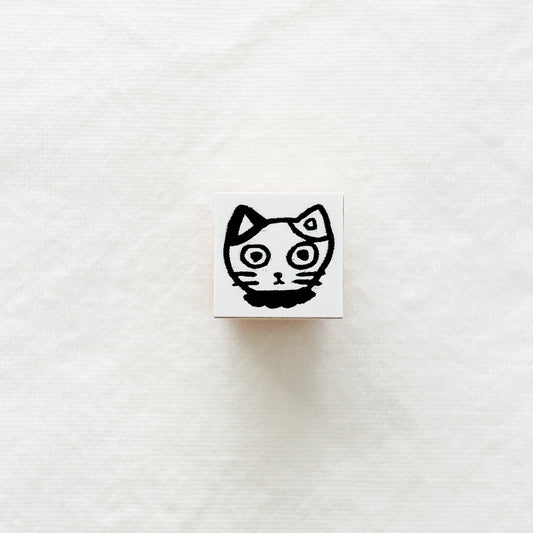 Small square wooden rubber stamp with a black and white cat.