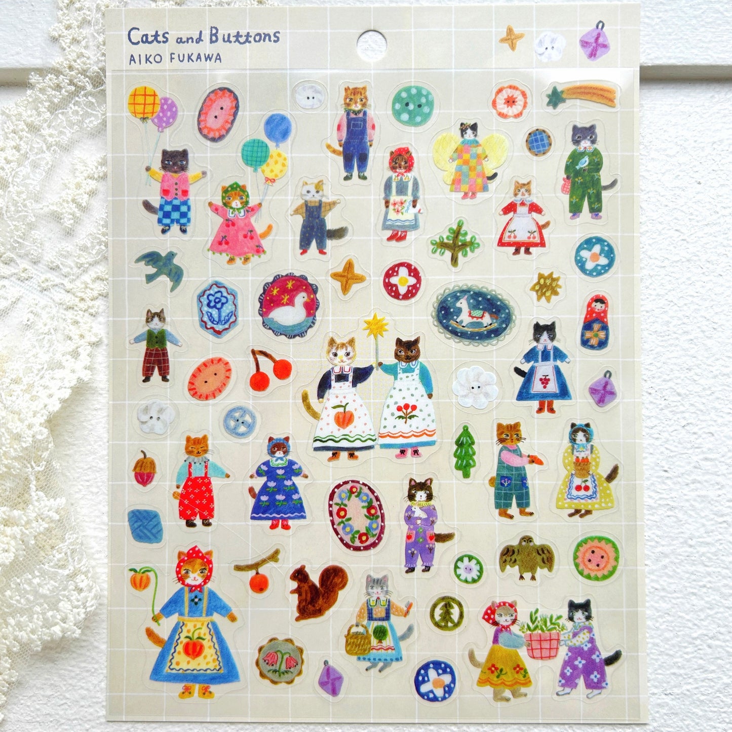 Sheet of colorful stickers featuring cats and buttons