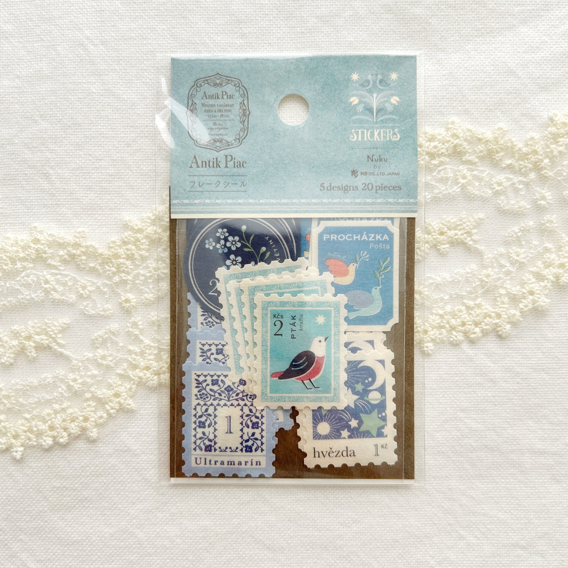 Packaged stickers with vintage design set in calming blue hues, illustrations features bunnies, birds, cats and fruits printed on textured Japanese paper.