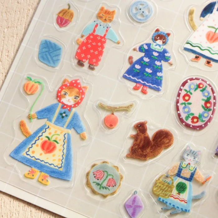 Aiko Fukawa clear sticker sheet titled 'Cats and Buttons,' featuring whimsical illustrations of playful cats and colorful buttons, Japanese stationery ideal for decorating planners, journals, and crafts.