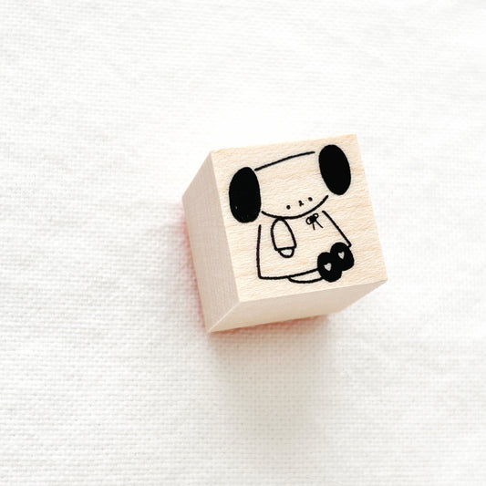 Wooden block stamp with an adorable dog wearing a dress