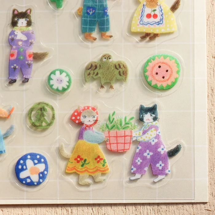 Aiko Fukawa clear sticker sheet titled 'Cats and Buttons,' featuring whimsical illustrations of playful cats and colorful buttons, Japanese stationery ideal for decorating planners, journals, and crafts.