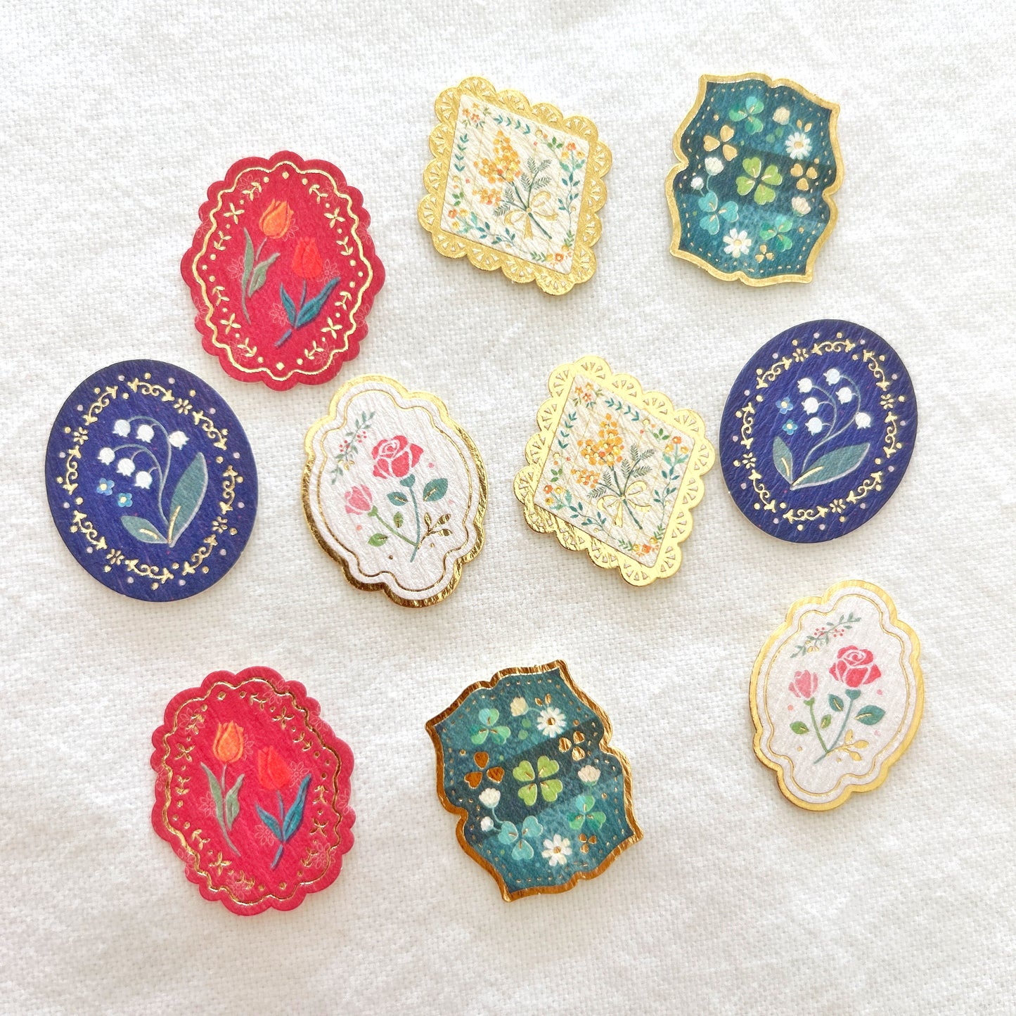 Individual flake stickers with floral design and gold accents