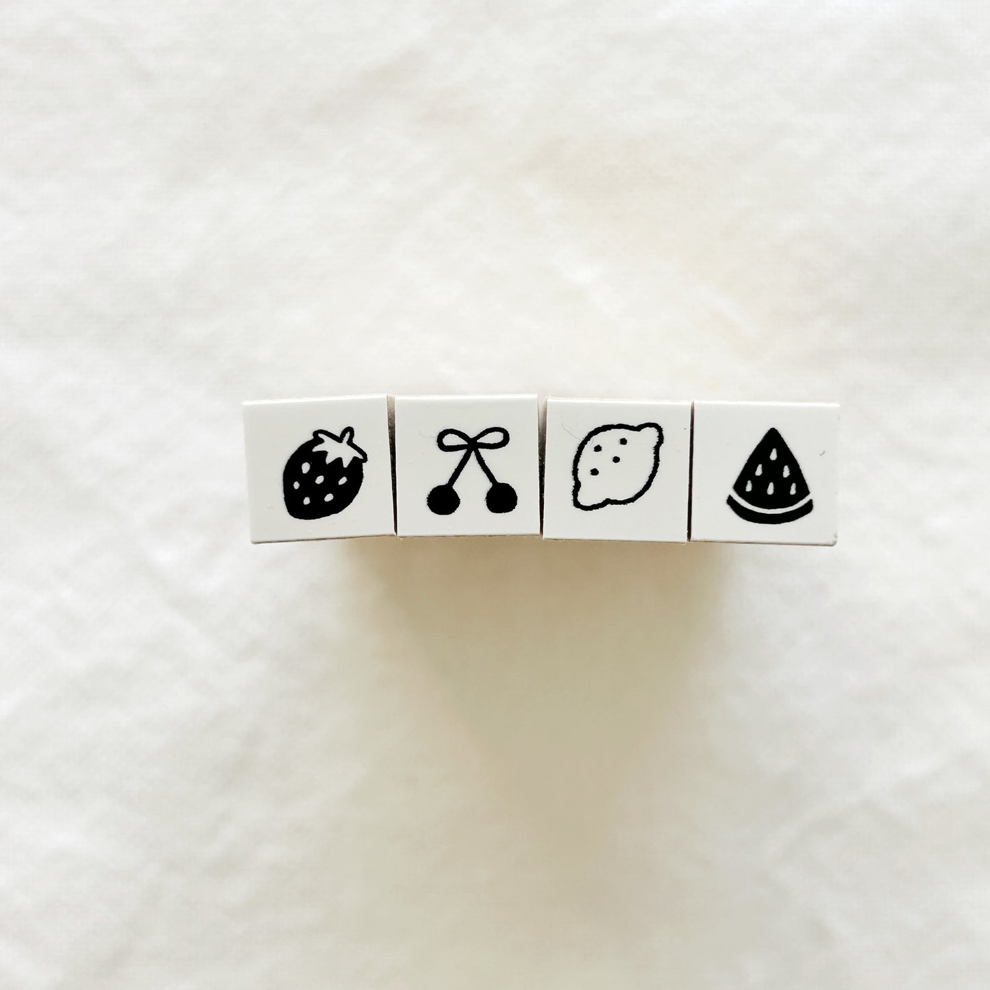 Set of four small rubber stamps with fruit designs. Strawberry, cherry, lemon and watermelon