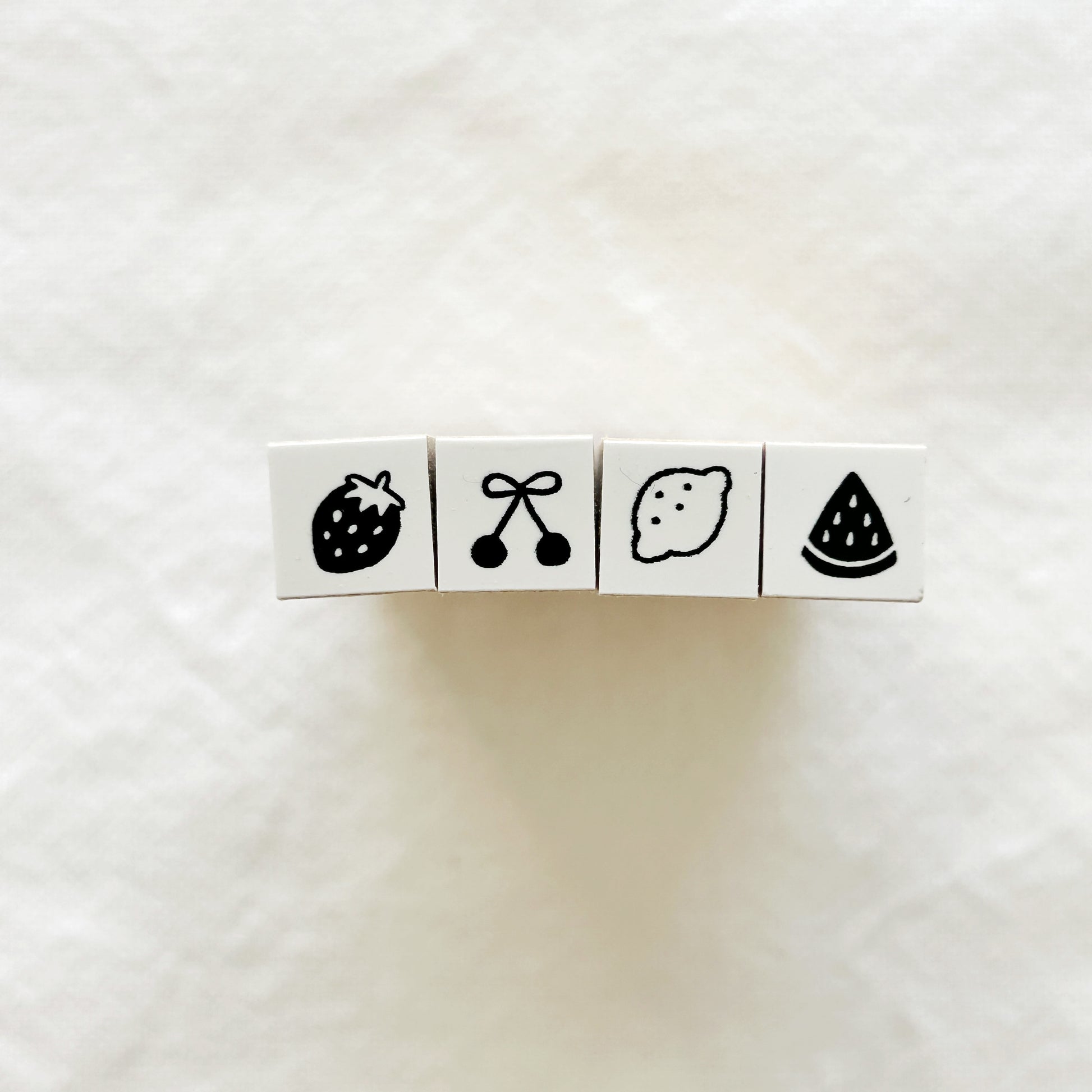 Set of four small rubber stamps with fruit designs. Strawberry, cherry, lemon and watermelon