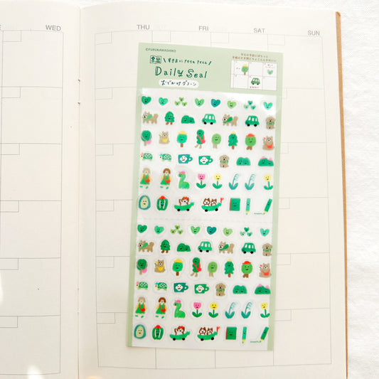 Sheet of cute green stickers with various designs on a white background
