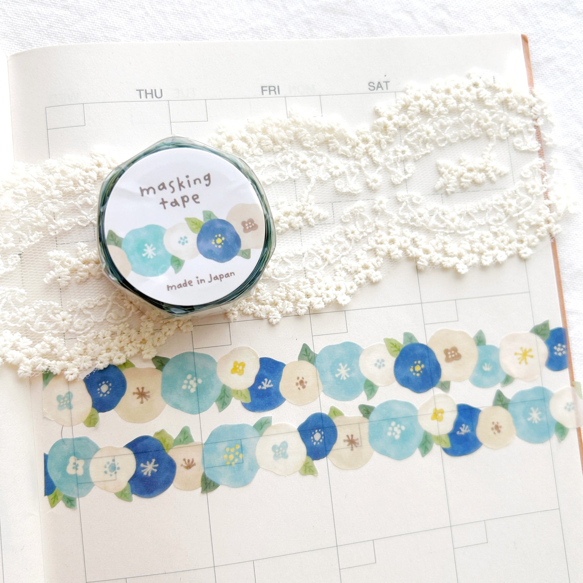 Washi tape with whimsical blue and white flowers design on a planner