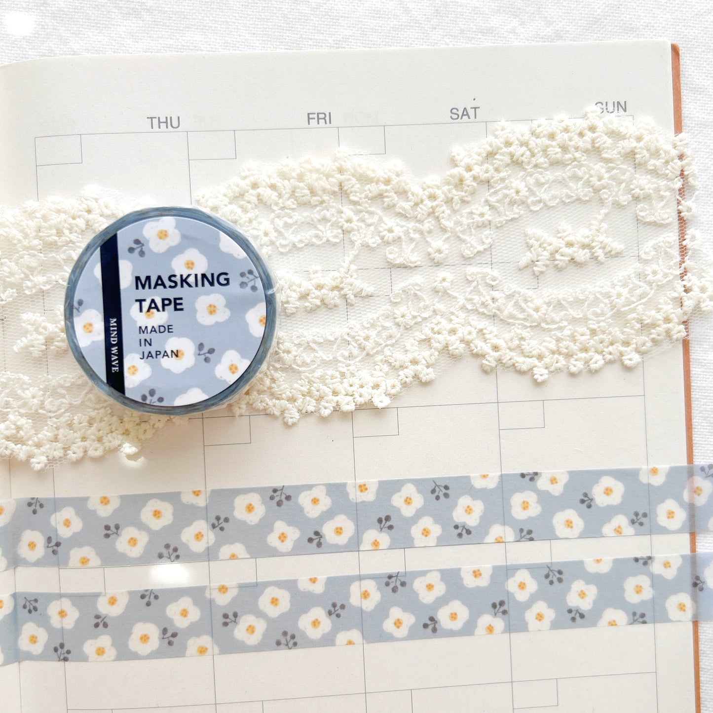 Washi tape with a whimsical blue and white floral design on a planner