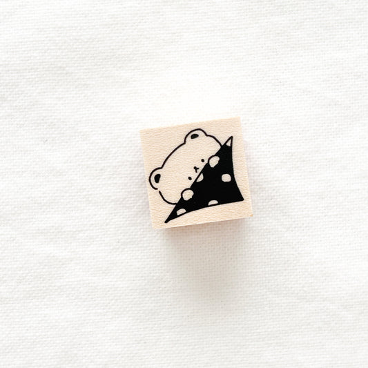 Small wooden stamp of a bear and polka dot blanket