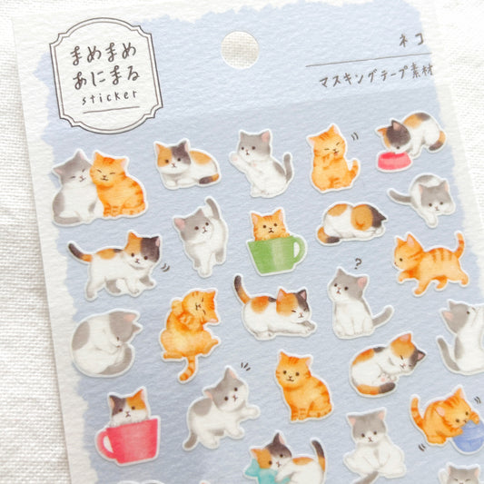 Sheet of cat-themed stickers on a light blue background