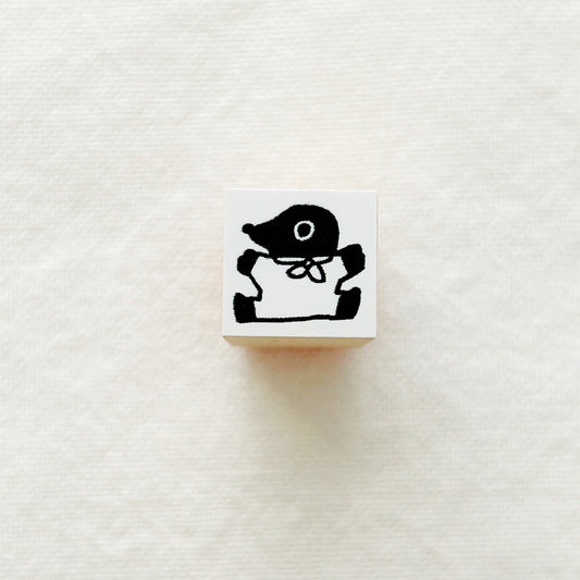 Small wooden rubber stamp of a black mole