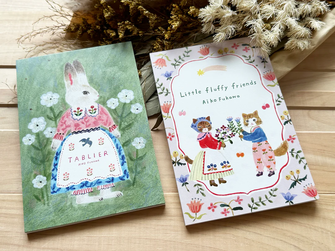 Aiko Fukawa postcard booklet titled 'Tablier,' featuring delightful illustrations of animals, flowers, and everyday scenes, Japanese stationery with a whimsical and artistic style.