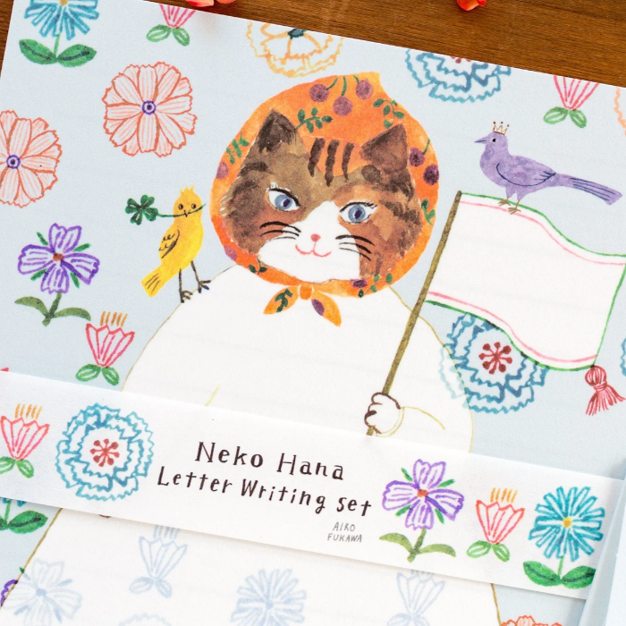 Aiko Fukawa letterhead featuring a cute cat and colorful floral design in a one-piece outfit, Japanese stationery with whimsical illustration style.