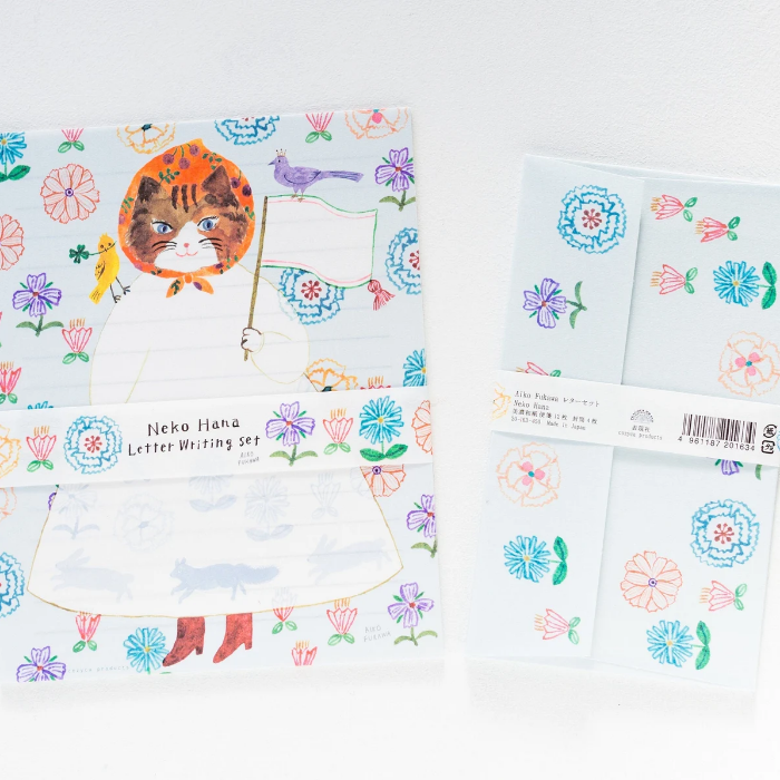 Aiko Fukawa letterhead featuring a cute cat and colorful floral design in a one-piece outfit, Japanese stationery with whimsical illustration style.