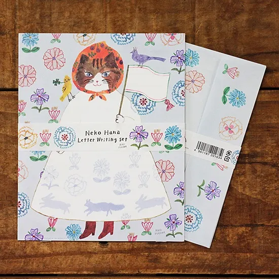 Aiko Fukawa letterhead featuring a cute cat and colorful floral design in a one-piece outfit, Japanese stationery with whimsical illustration style.