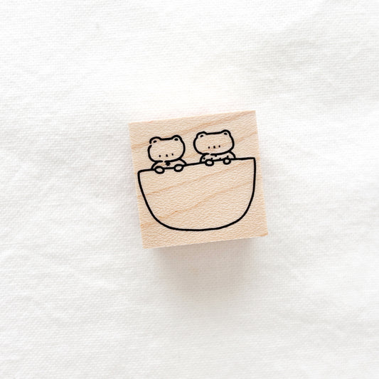 Wooden stamp with two bear sitting in a pocket