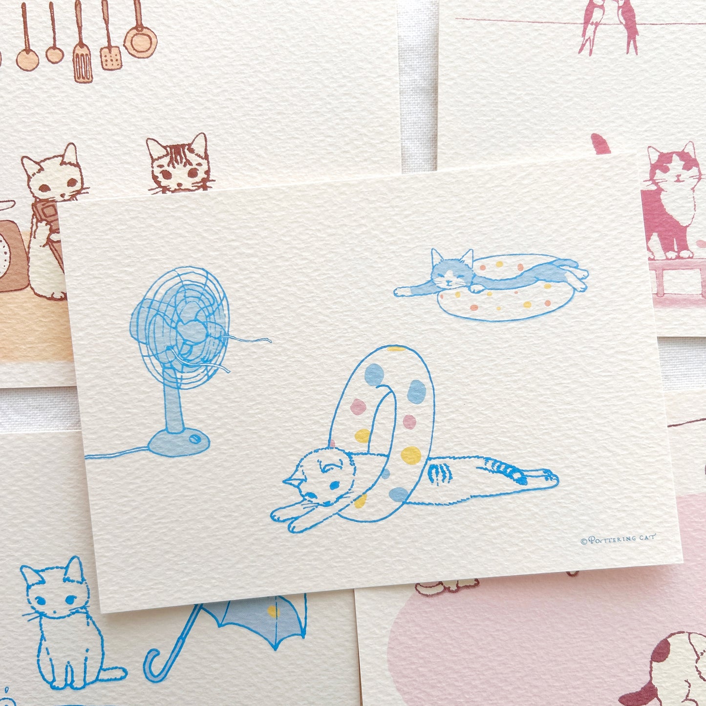A collection of postcards with cute cat illustrations