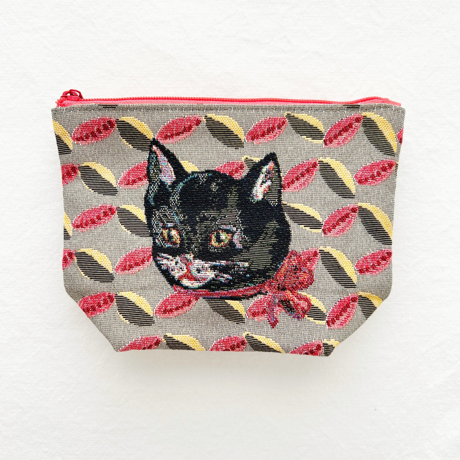 Small pouch with a black cat design on a floral patterned background