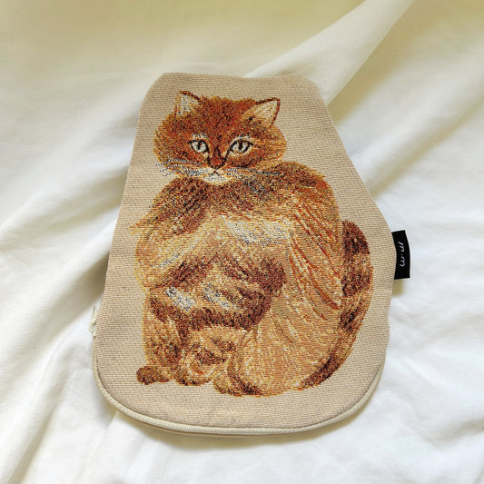 Embroidered cat design on a beige pouch