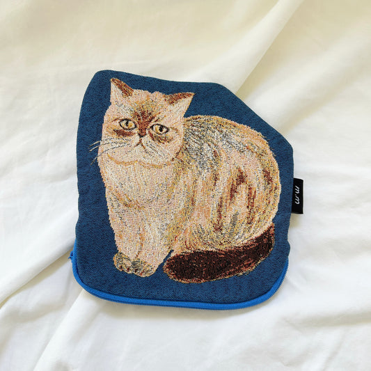 Embroidered patch of a cat on a blue background