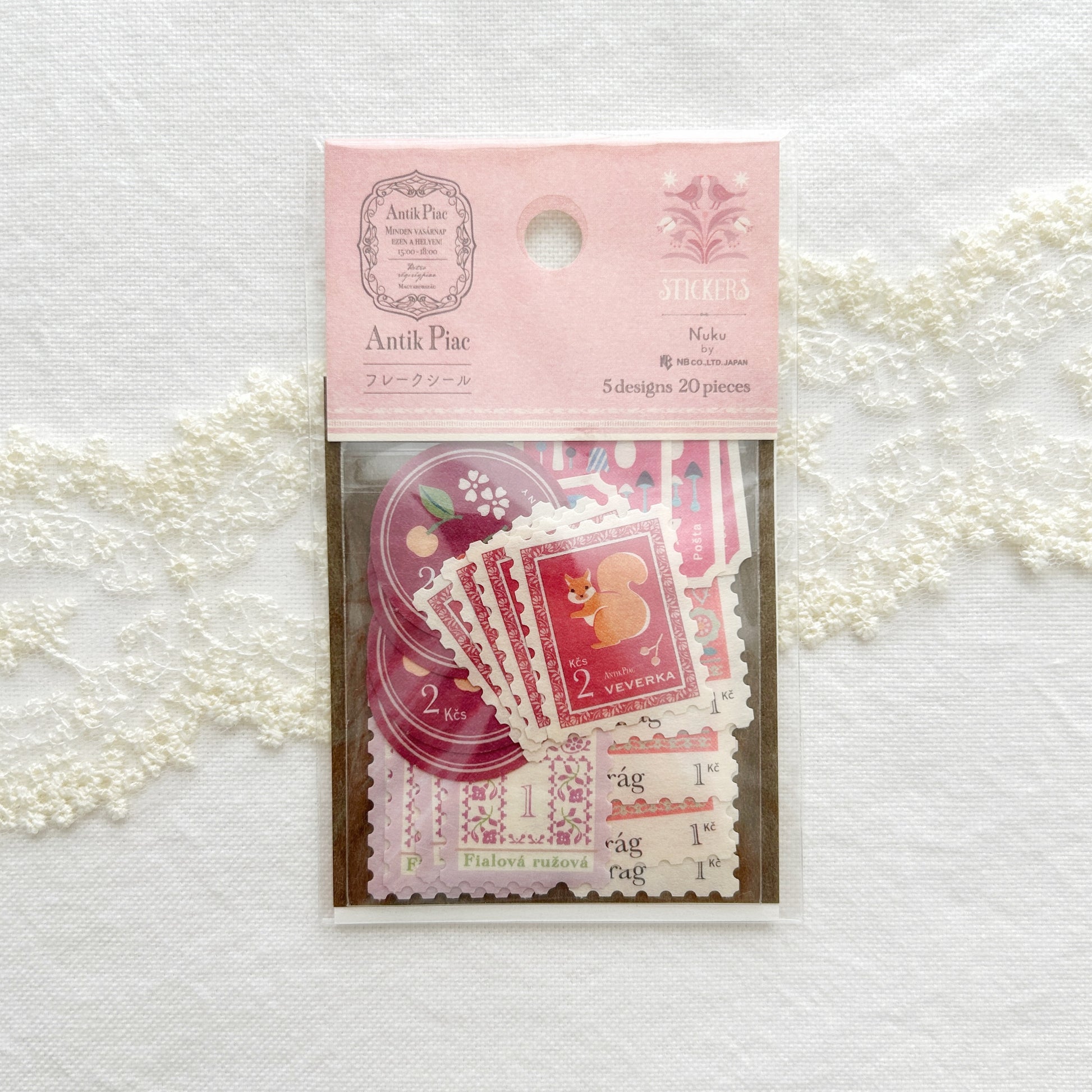 Packaged stickers set in calming pink hues, illustrations features squirrels, mouse, fruits, and flowers printed on textured Japanese paper.