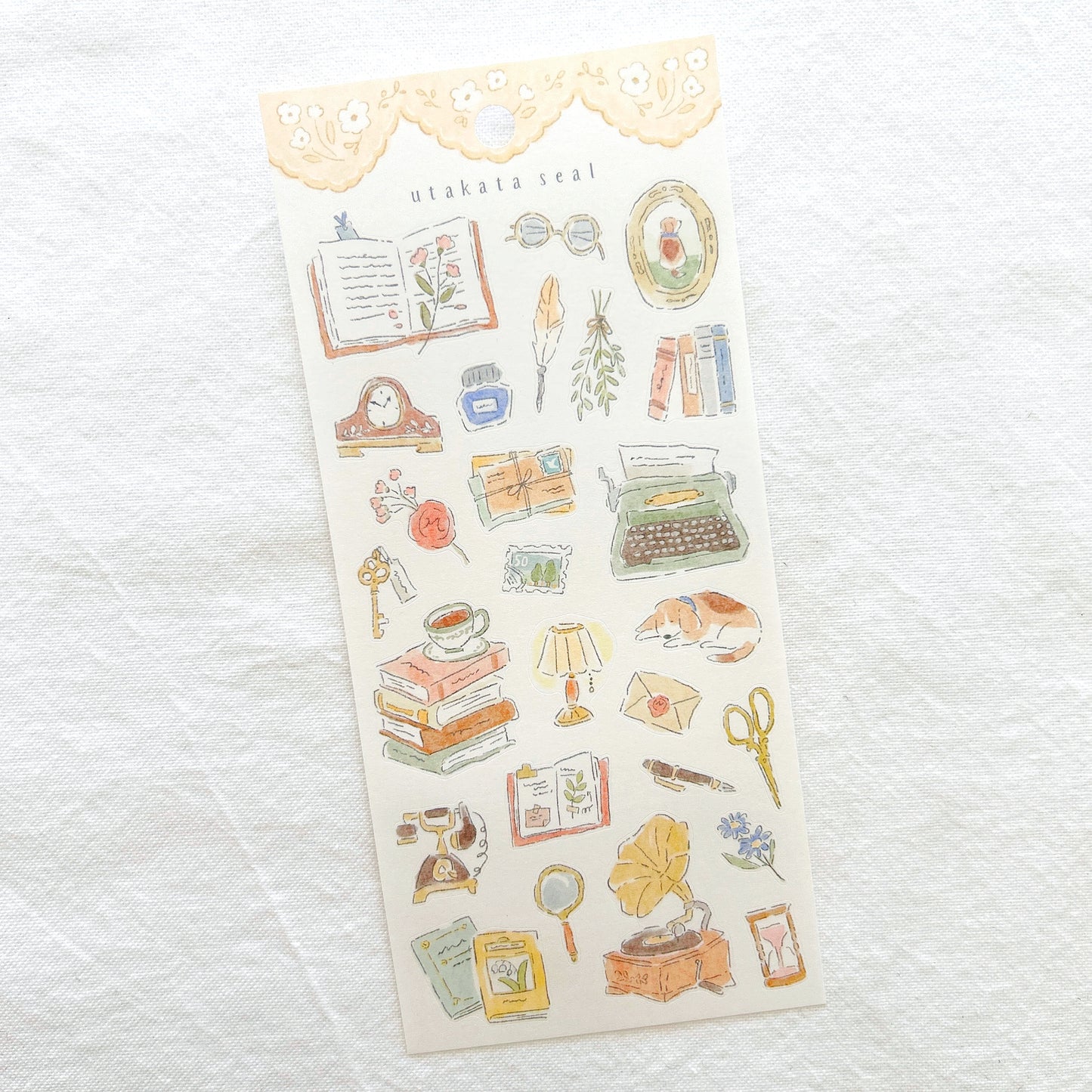 Sheet of decorative stickers with vintage-themed illustrations including typewriter, mantel clock and record player