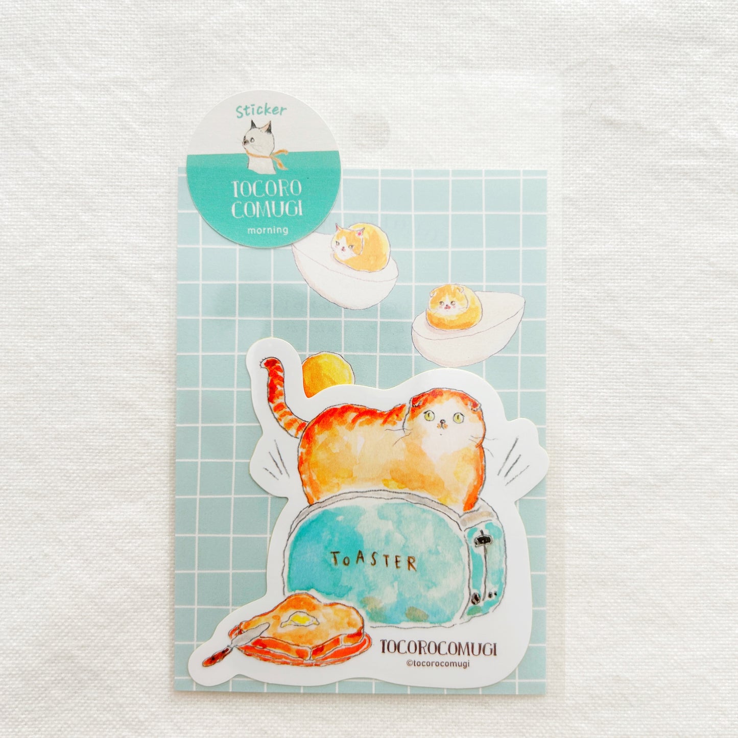 A sticker of a toaster with a cat in it